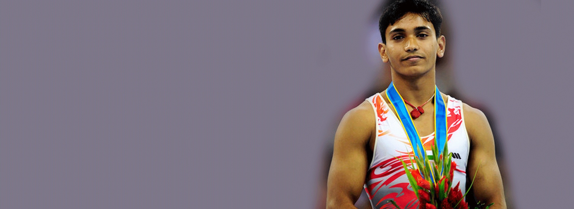 Ashish Kumar on the podium wearing a medal